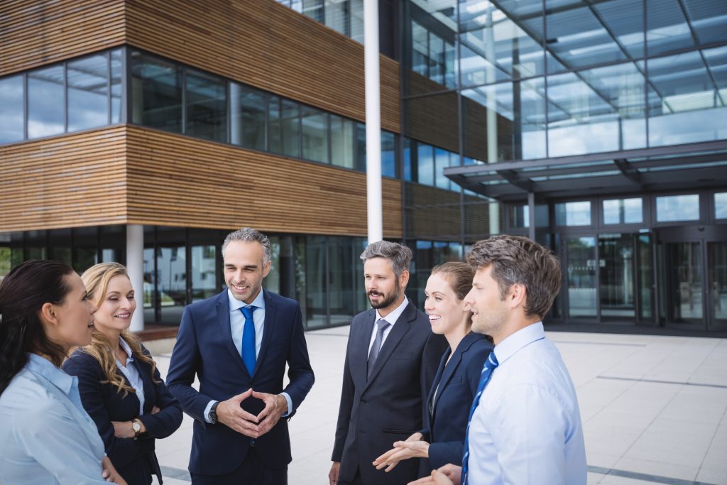 group businesspeople interacting outside office building Real Estate Women group businesspeople interacting outside office building Real Estate Women